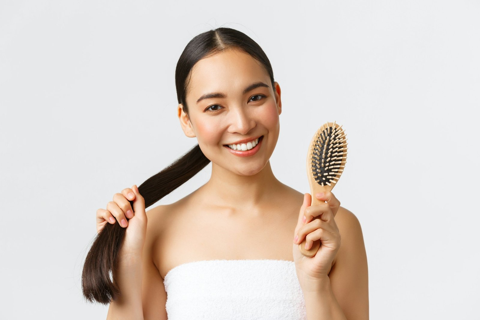 Beauty, hair loss products, shampoo and hair care concept. Close-up of happy attractive asian woman