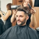 Positive delighted man waiting for new hairstyle