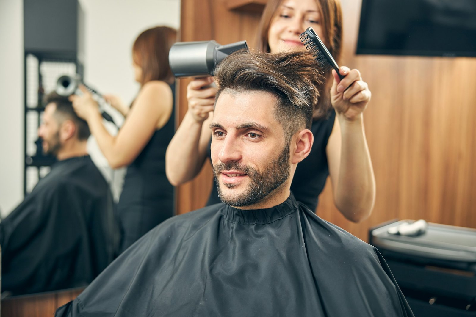 Positive delighted man waiting for new hairstyle