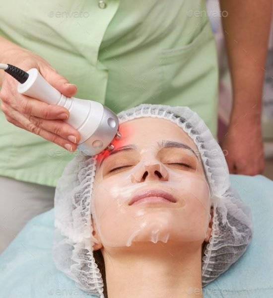 Female face, rf skin tightening. Young woman in facial mask.