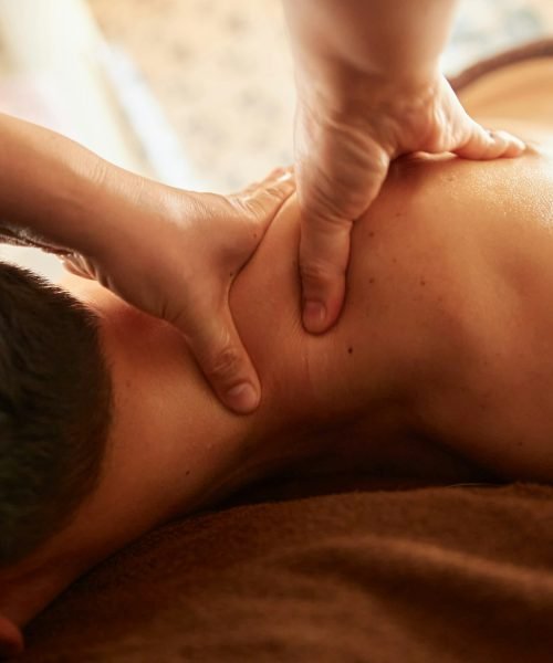 Asian man receiving shoulder massage