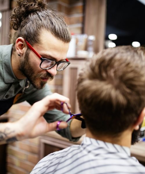 Client during beard and moustache grooming in barber shop