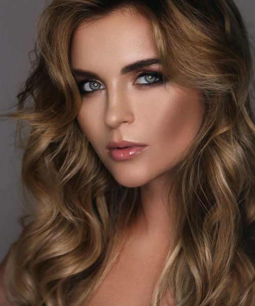 Gorgeous woman with a beautiful curly hair and professional makeup