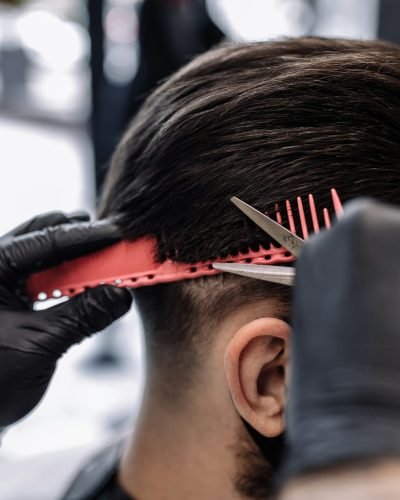 Men's haircut in a barbershop. Styling and hair care.