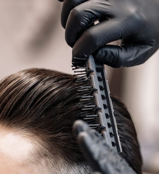 Men's haircut in a barbershop. Styling and hair care.