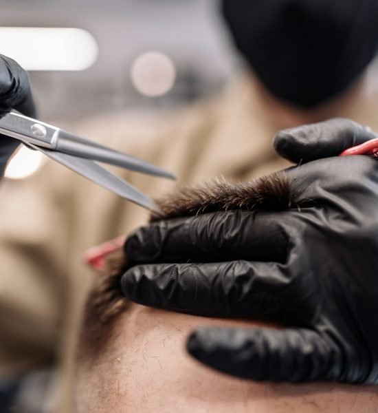 Men's haircut in a barbershop. Styling and hair care.