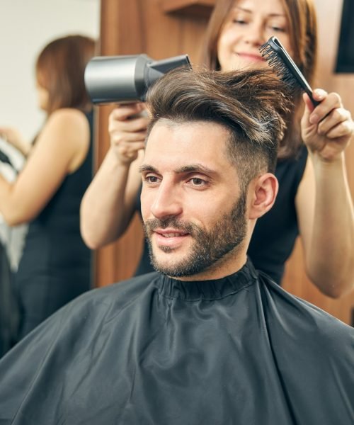 Positive delighted man waiting for new hairstyle